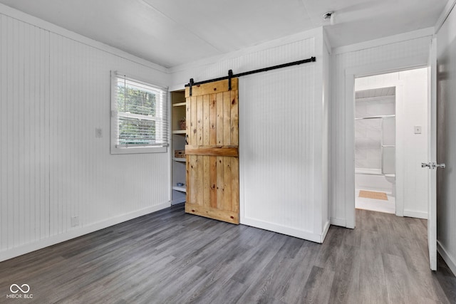 917 W Busby St, Lebanon, IN 46052 - unfurnished bedroom featuring wood finished floors and a barn door