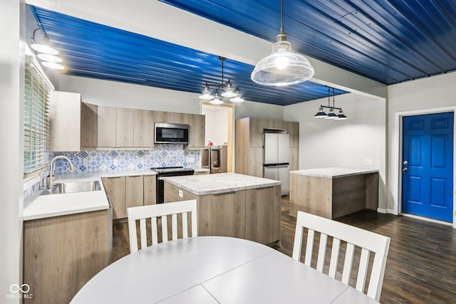 3921 S Lasalle St, Indianapolis, IN 46237 - kitchen with stainless steel microwave, range with electric stovetop, freestanding refrigerator, light countertops, and a kitchen island