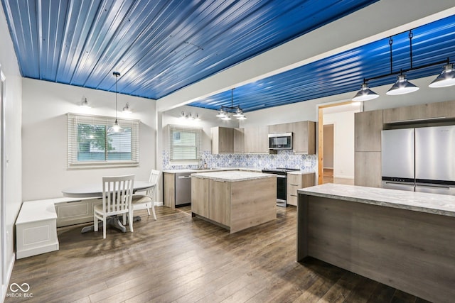 3921 S Lasalle St, Indianapolis, IN 46237 - kitchen with appliances with stainless steel finishes, dark wood-style flooring, a center island, modern cabinets, and tasteful backsplash