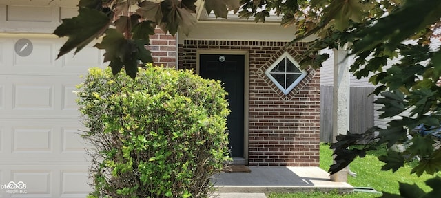 403 Bagley Ln, Indianapolis, IN 46231 - view of exterior entry featuring brick siding and a garage