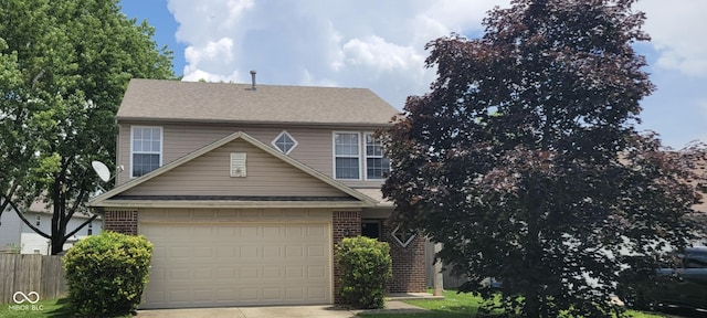 403 Bagley Ln, Indianapolis, IN 46231 - view of front facade with driveway, brick siding, a shingled roof, and a garage