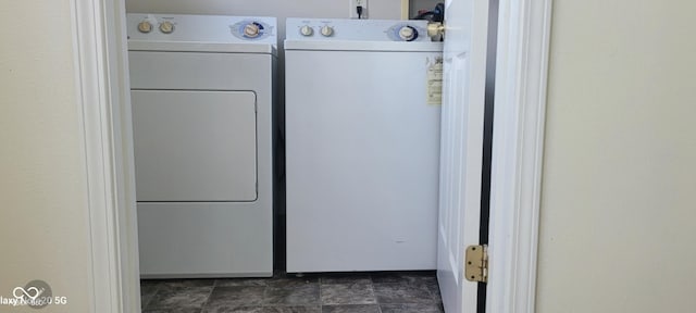 403 Bagley Ln, Indianapolis, IN 46231 - washroom featuring washer and clothes dryer and dark stone finish floors
