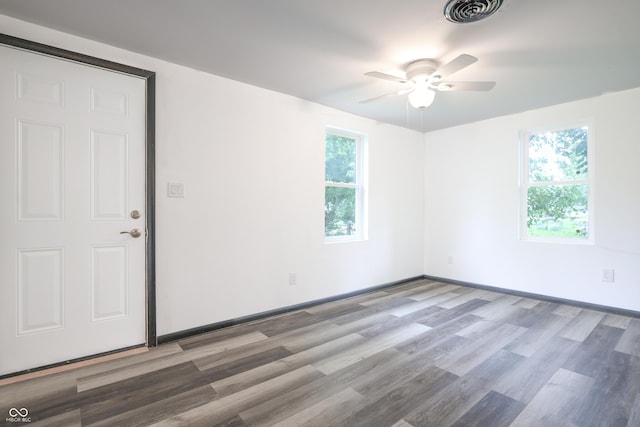 523 Patterson Rd, Columbus, IN 47203 - empty room featuring wood finished floors, healthy amount of natural light, and ceiling fan