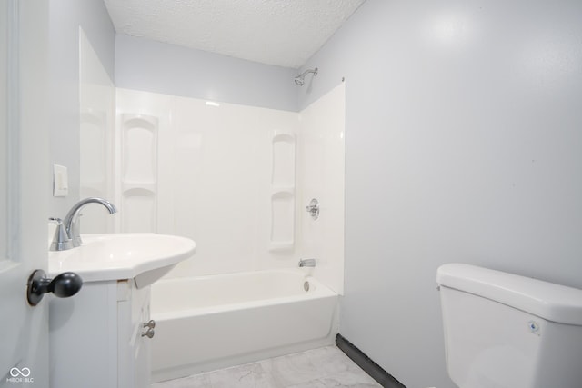 523 Patterson Rd, Columbus, IN 47203 - bathroom featuring washtub / shower combination, a textured ceiling, vanity, and marble finish floors