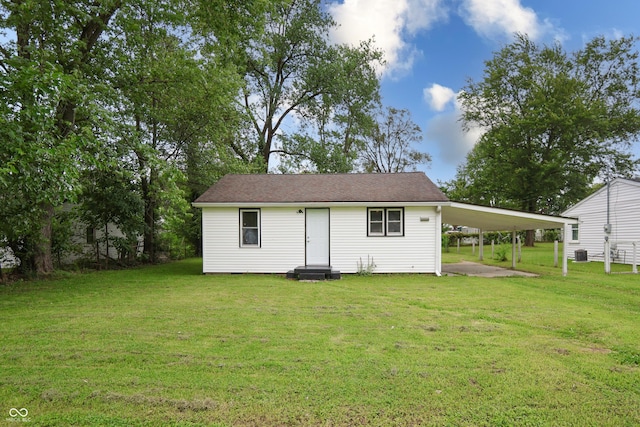 523 Patterson Rd, Columbus, IN 47203 - rear view of house featuring a lawn and an attached carport