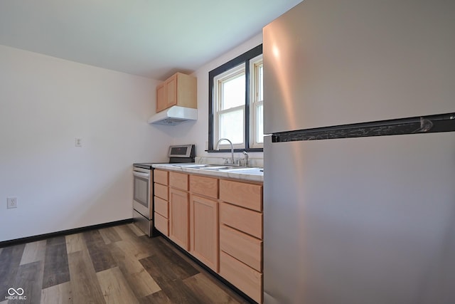 523 Patterson Rd, Columbus, IN 47203 - kitchen featuring stainless steel appliances, under cabinet range hood, light brown cabinets, and dark wood finished floors