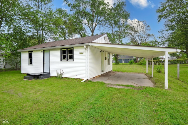 523 Patterson Rd, Columbus, IN 47203 - rear view of property with a lawn, an attached carport, and driveway