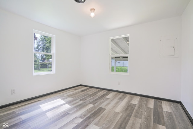 523 Patterson Rd, Columbus, IN 47203 - empty room with electric panel, healthy amount of natural light, and wood finished floors
