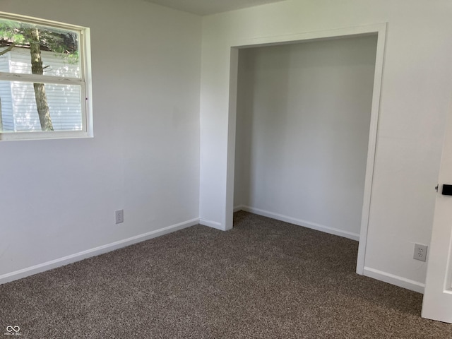321 S 23rd St, Elwood, IN 46036 - unfurnished bedroom with dark carpet and baseboards
