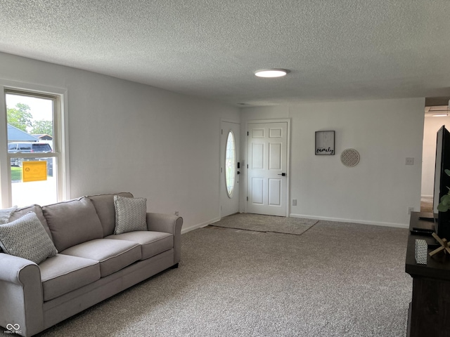 321 S 23rd St, Elwood, IN 46036 - carpeted living room featuring a textured ceiling and baseboards