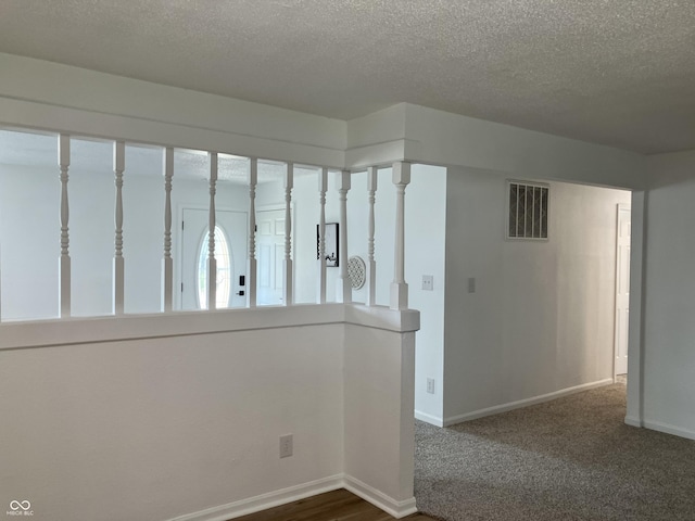 321 S 23rd St, Elwood, IN 46036 - hall with a textured ceiling and dark carpet