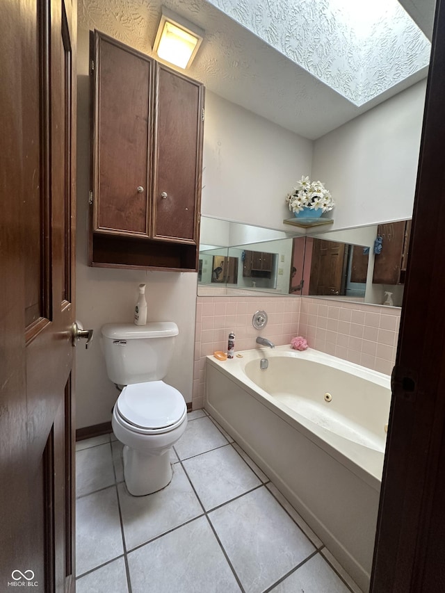 8849 Summer Walk Dr E, Indianapolis, IN 46227 - bathroom featuring a whirlpool tub, tile patterned floors, and a skylight