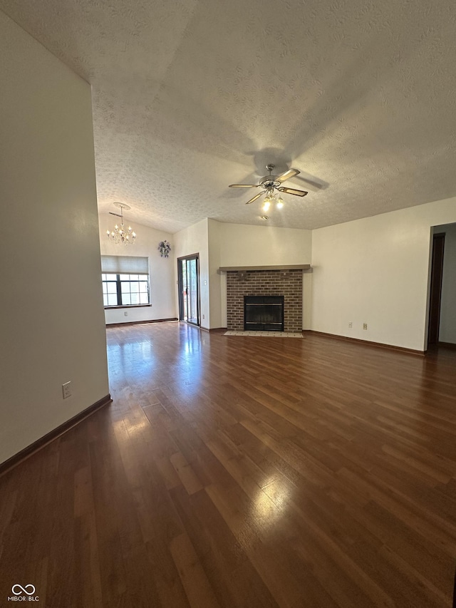 8849 Summer Walk Dr E, Indianapolis, IN 46227 - unfurnished living room with a textured ceiling, a ceiling fan, dark wood finished floors, a chandelier, and vaulted ceiling