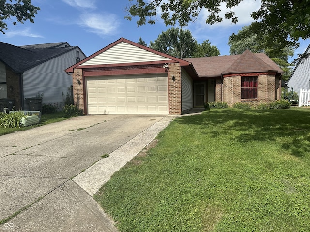 8849 Summer Walk Dr E, Indianapolis, IN 46227 - ranch-style house featuring brick siding, a front lawn, an attached garage, and concrete driveway