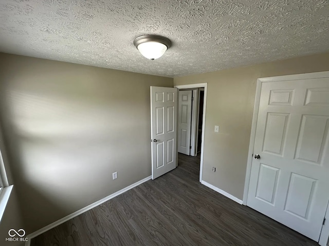 10316 Woodhaven Cir, Indianapolis, IN 46229 - unfurnished bedroom with dark wood-type flooring and a textured ceiling