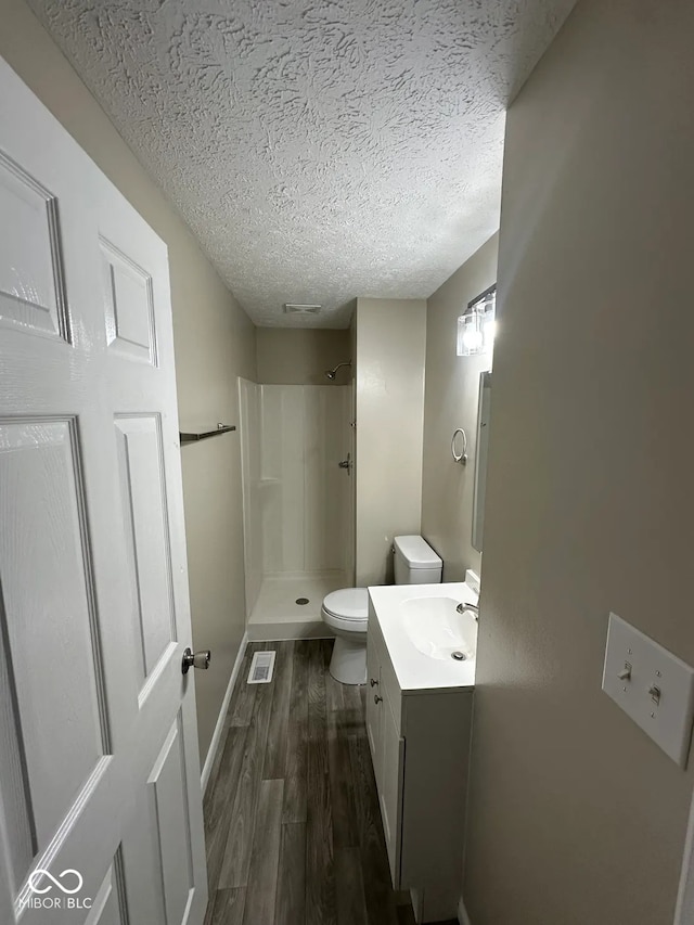 10316 Woodhaven Cir, Indianapolis, IN 46229 - full bath with a stall shower, wood finished floors, vanity, and a textured ceiling