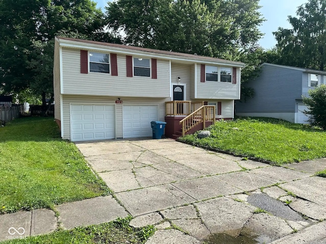 10316 Woodhaven Cir, Indianapolis, IN 46229 - split foyer home featuring a front lawn, concrete driveway, and an attached garage