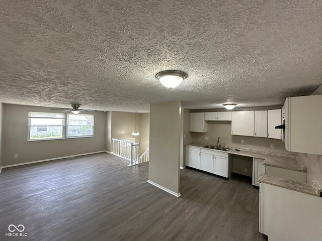 10316 Woodhaven Cir, Indianapolis, IN 46229 - kitchen with dark wood finished floors, a textured ceiling, white cabinetry, ceiling fan, and light countertops