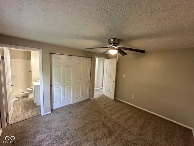 10316 Woodhaven Cir, Indianapolis, IN 46229 - unfurnished bedroom featuring carpet flooring, a closet, a textured ceiling, ensuite bathroom, and ceiling fan