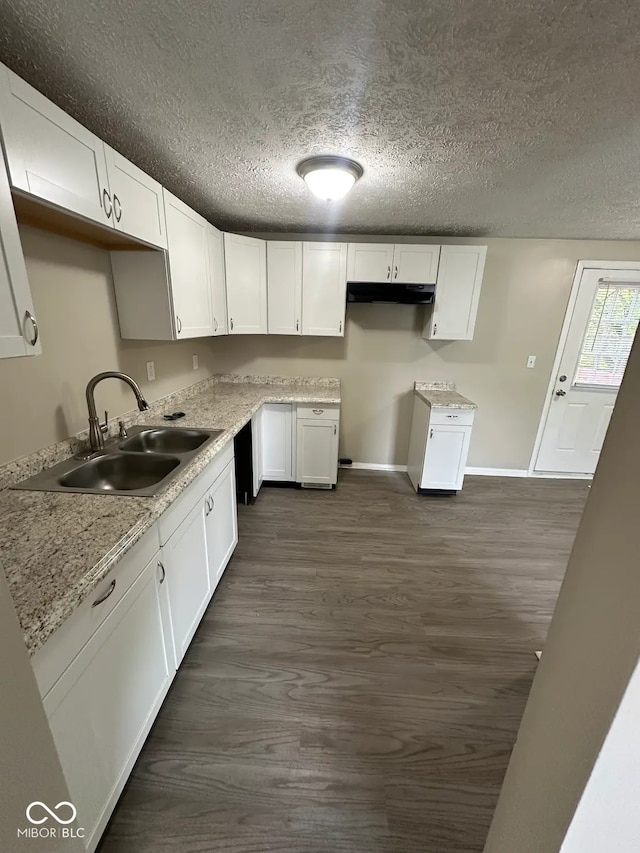 10316 Woodhaven Cir, Indianapolis, IN 46229 - kitchen featuring dark wood-style floors, a textured ceiling, white cabinets, and under cabinet range hood