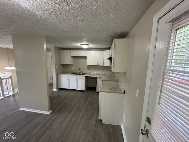 10316 Woodhaven Cir, Indianapolis, IN 46229 - kitchen featuring a textured ceiling, dark wood finished floors, a chandelier, and white cabinetry