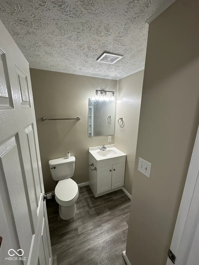 10316 Woodhaven Cir, Indianapolis, IN 46229 - bathroom featuring a textured ceiling, vanity, and wood finished floors