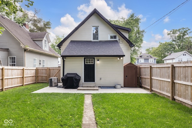 3035 Guilford Ave, Indianapolis, IN 46205 - back of property featuring a patio, a fenced backyard, a shingled roof, entry steps, and an outbuilding