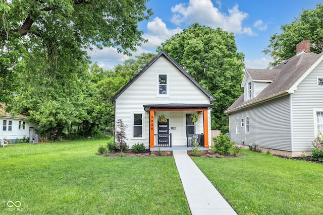 3035 Guilford Ave, Indianapolis, IN 46205 - view of front facade with covered porch and a front yard