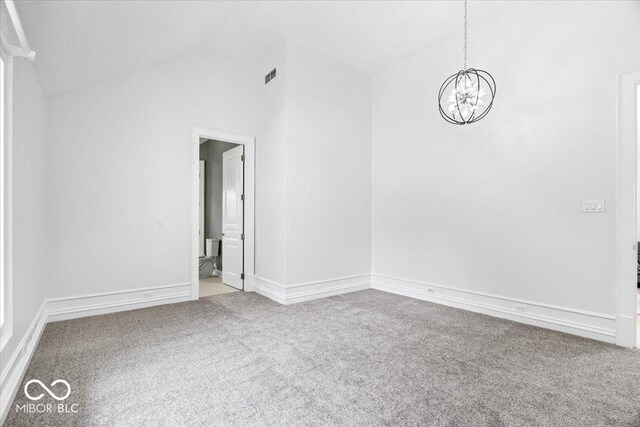 12208 Island Dr, Indianapolis, IN 46256 - unfurnished room with carpet flooring, a chandelier, and vaulted ceiling