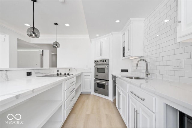 12208 Island Dr, Indianapolis, IN 46256 - kitchen with double oven, white cabinetry, ornamental molding, tasteful backsplash, and light stone counters