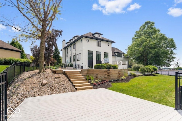 12208 Island Dr, Indianapolis, IN 46256 - view of front of property with a fenced backyard, stairway, a chimney, a deck, and stucco siding