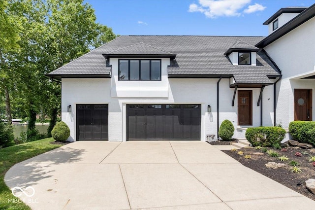 12208 Island Dr, Indianapolis, IN 46256 - view of front of property with brick siding, driveway, a high end roof, and a garage