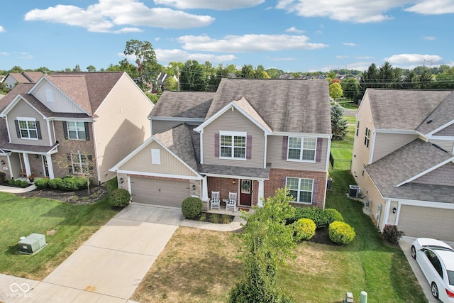 14453 Glapthorn Rd, Fishers, IN 46037 - traditional home featuring brick siding, an attached garage, concrete driveway, a porch, and a front yard