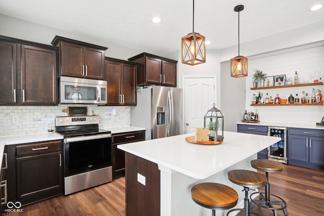 14453 Glapthorn Rd, Fishers, IN 46037 - kitchen featuring stainless steel appliances, wine cooler, dark wood finished floors, decorative backsplash, and light countertops