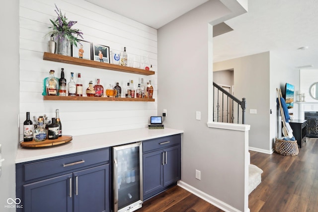 14453 Glapthorn Rd, Fishers, IN 46037 - indoor dry bar featuring beverage cooler, dark wood finished floors, and stairs