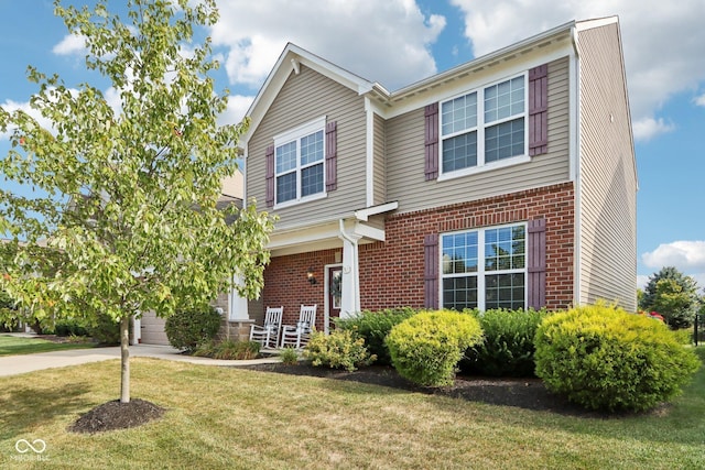 14453 Glapthorn Rd, Fishers, IN 46037 - view of front of house featuring brick siding, a porch, a front lawn, and driveway