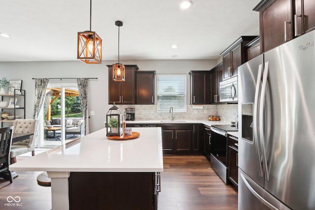 14453 Glapthorn Rd, Fishers, IN 46037 - kitchen featuring appliances with stainless steel finishes, plenty of natural light, dark brown cabinets, tasteful backsplash, and recessed lighting