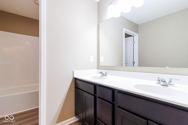 6610 Aberdeen Dr, Mccordsville, IN 46055 - bathroom with double vanity, wood finished floors, and shower / washtub combination
