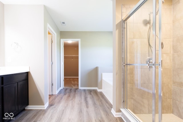 6610 Aberdeen Dr, Mccordsville, IN 46055 - full bath featuring a garden tub, wood finished floors, a stall shower, a spacious closet, and vanity