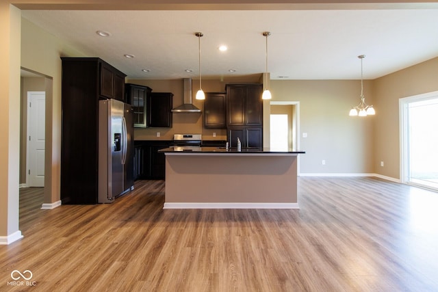 6610 Aberdeen Dr, Mccordsville, IN 46055 - kitchen with wall chimney range hood, stainless steel appliances, dark countertops, light wood-type flooring, and hanging light fixtures