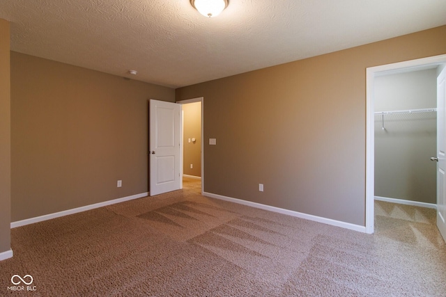6610 Aberdeen Dr, Mccordsville, IN 46055 - unfurnished bedroom with carpet floors, a spacious closet, a closet, and a textured ceiling