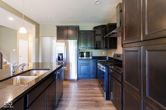 6610 Aberdeen Dr, Mccordsville, IN 46055 - kitchen with stainless steel appliances, wall chimney range hood, wood finished floors, dark stone countertops, and pendant lighting