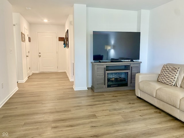 213 Drewood Dr, Trafalgar, IN 46181 - living room featuring a glass covered fireplace, light wood-type flooring, and recessed lighting
