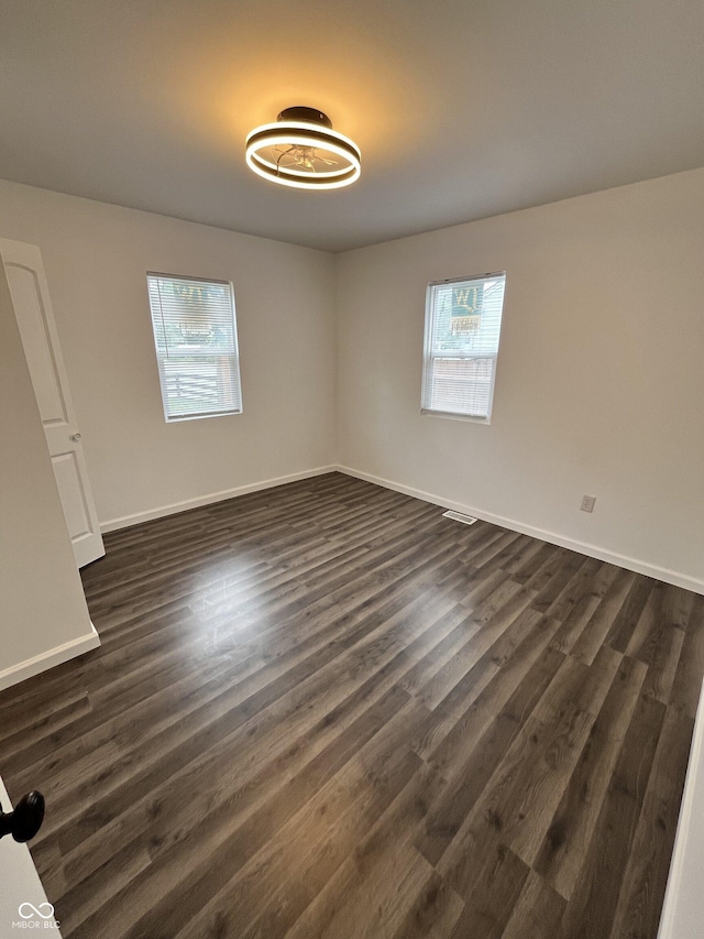 3201 W 22nd St, Indianapolis, IN 46222 - unfurnished bedroom with dark wood-style flooring