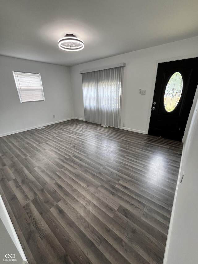 3201 W 22nd St, Indianapolis, IN 46222 - unfurnished living room with plenty of natural light and dark wood-type flooring