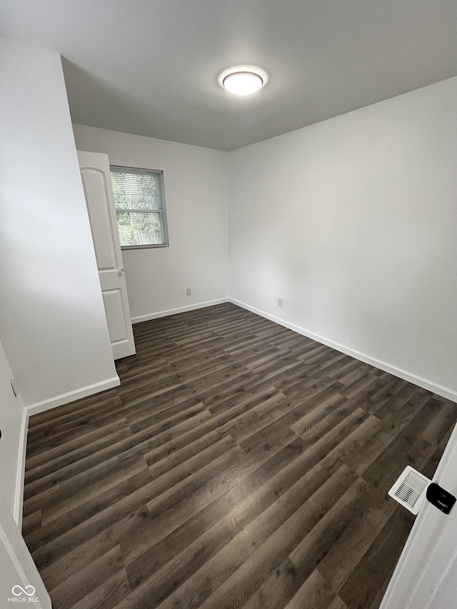 3201 W 22nd St, Indianapolis, IN 46222 - empty room featuring dark wood-type flooring and baseboards