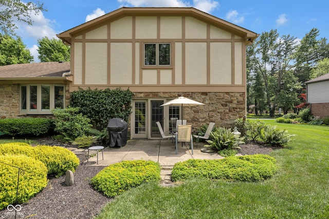 8525 Winding Ridge Rd, Indianapolis, IN 46217 - back of property with stone siding, a lawn, a patio, and stucco siding