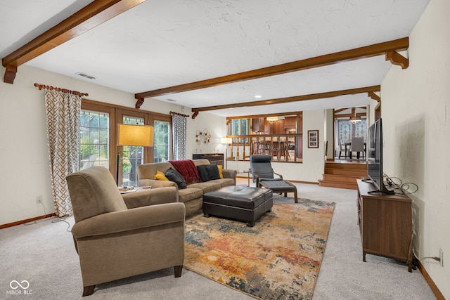 8525 Winding Ridge Rd, Indianapolis, IN 46217 - living room featuring beam ceiling, light colored carpet, and stairs