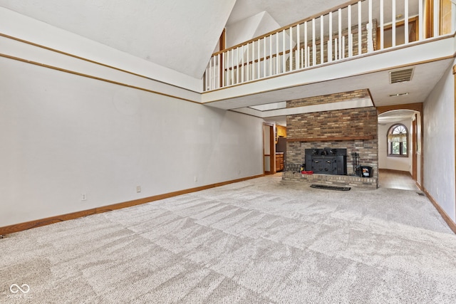 396 W 500 S, Anderson, IN 46013 - unfurnished living room with carpet floors, high vaulted ceiling, arched walkways, and a fireplace