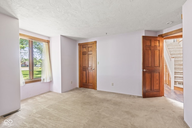 396 W 500 S, Anderson, IN 46013 - carpeted empty room with stairway and a textured ceiling